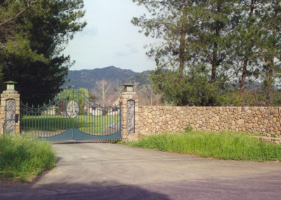 Bell Curve Bi-Parting Driveway Gate w/ Cracked Granite Center Olive Motif & Coordinating Columns Niches