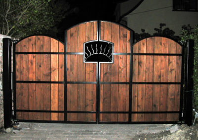Custom Bi-Parting Driveway Gate w/ 3 Panels. Features Sun Ray Window, Arched Steel Frame w/ Wood Infill