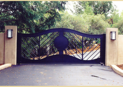 Bell Curve Driveway Gate - Angled Pickets, Solid Circular Center and Large Recessed Frame Panels for a Modern Design.