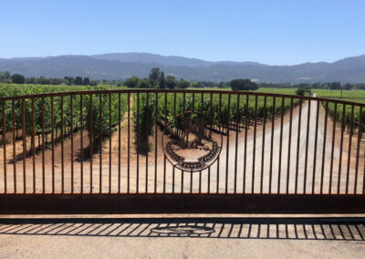 Arch Top Driveway Gate - Natural Patina Bare Metal w/ Custom Logo Center